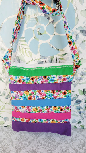 Colorful striped bag with floral pattern on a floral background
