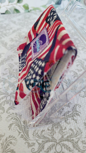 American flag-patterned fabric on a decorative glass plate with a floral background