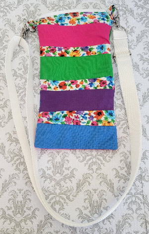 Colorful fabric bag with floral pattern on a textured gray background