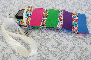 Colorful striped bag with floral pattern on a floral background