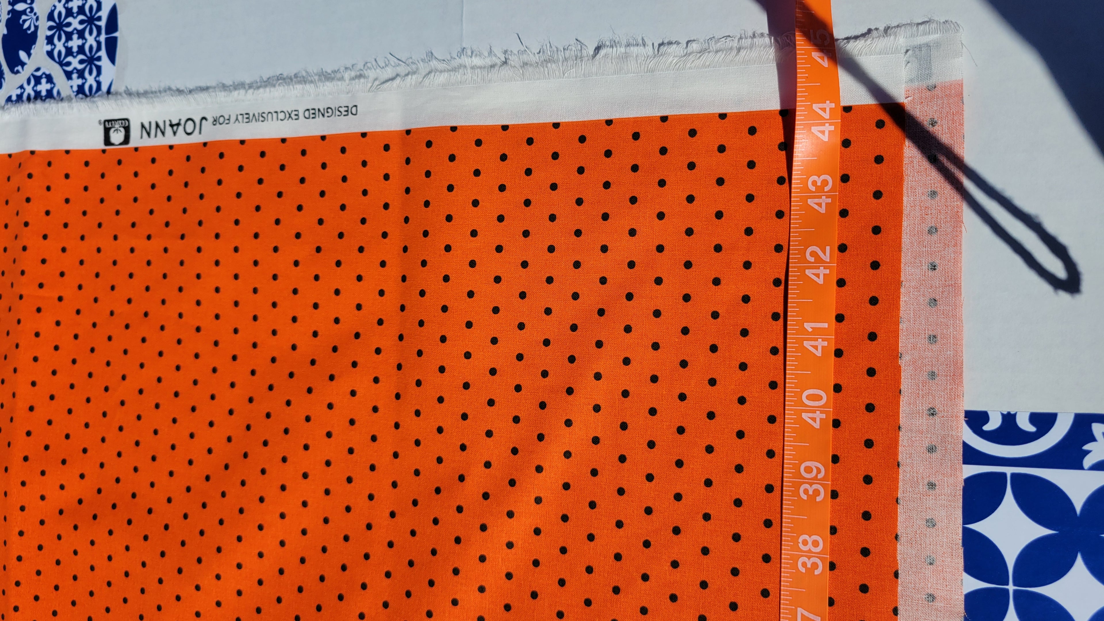 Black polka dot pattern on Orange Fabric.