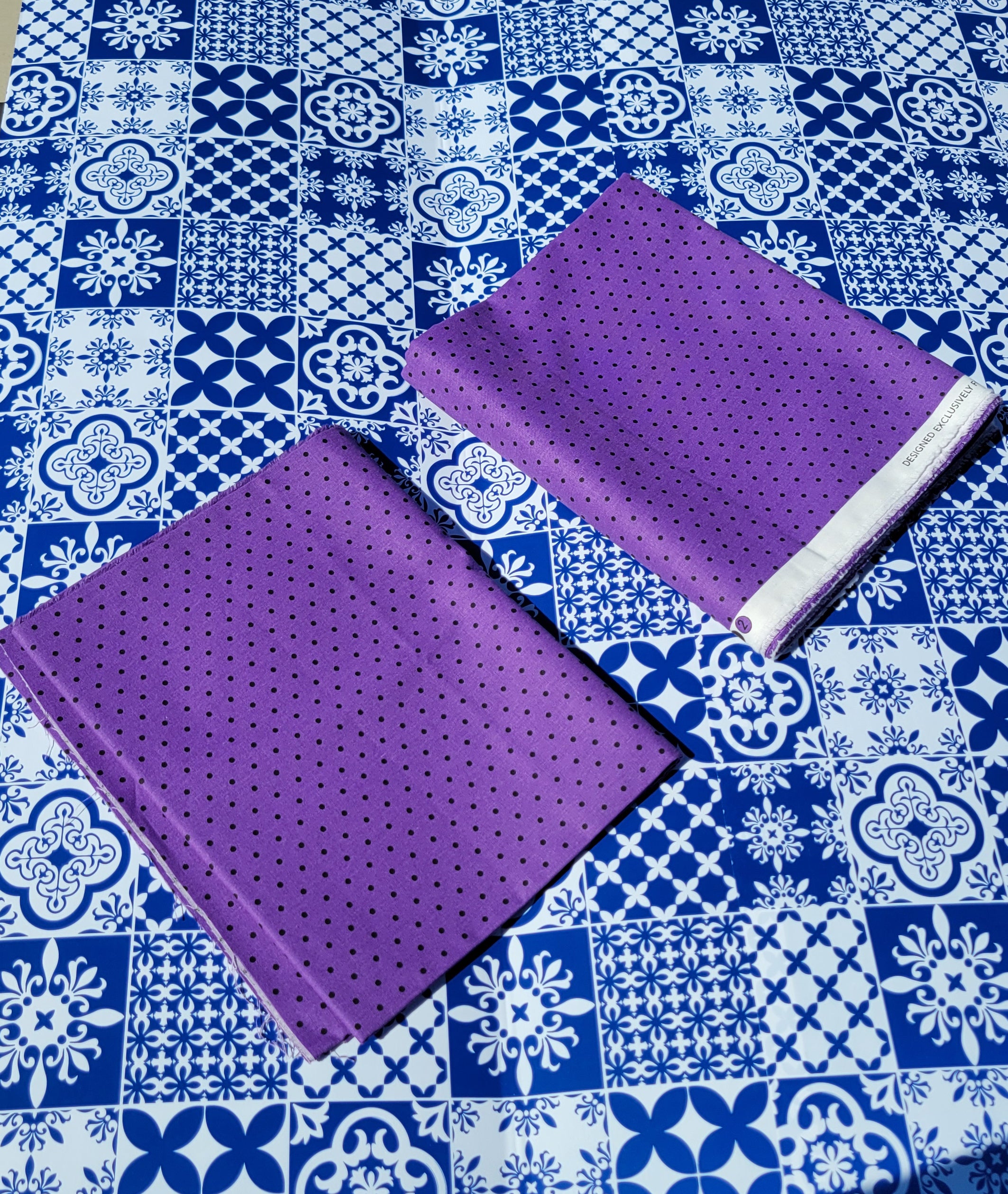 Small Black dots on Purple Fabric