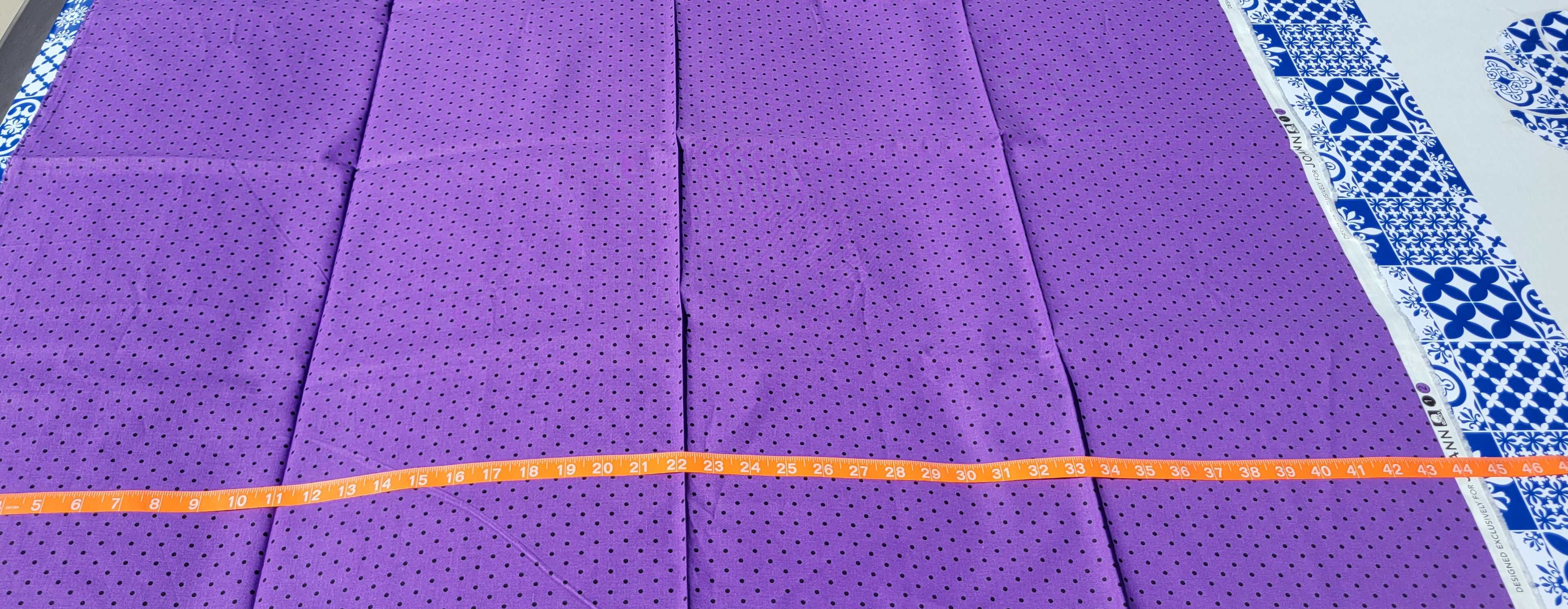 Small Black dots on Purple Fabric