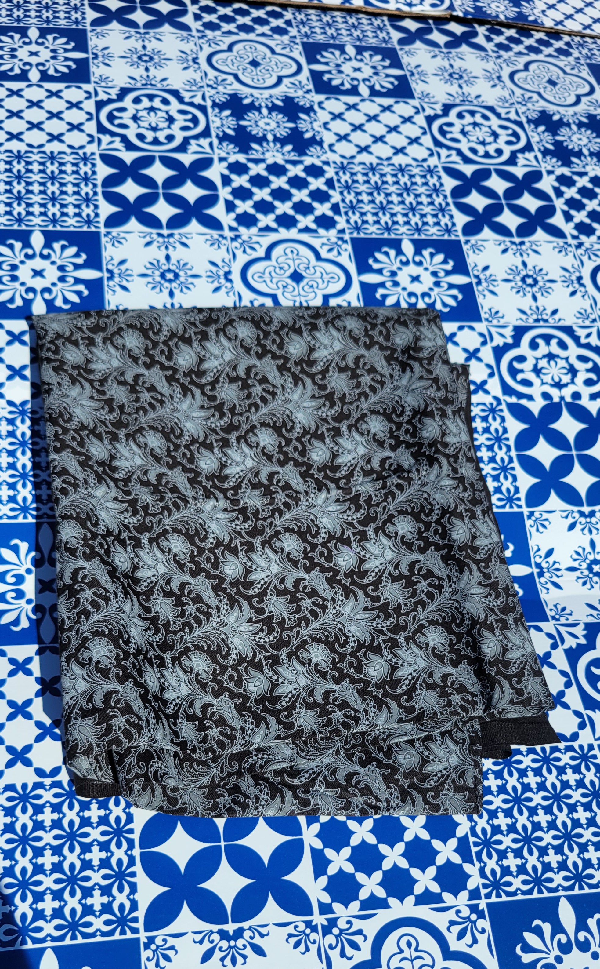 Detail White Paisley Pattern on Black Fabric.