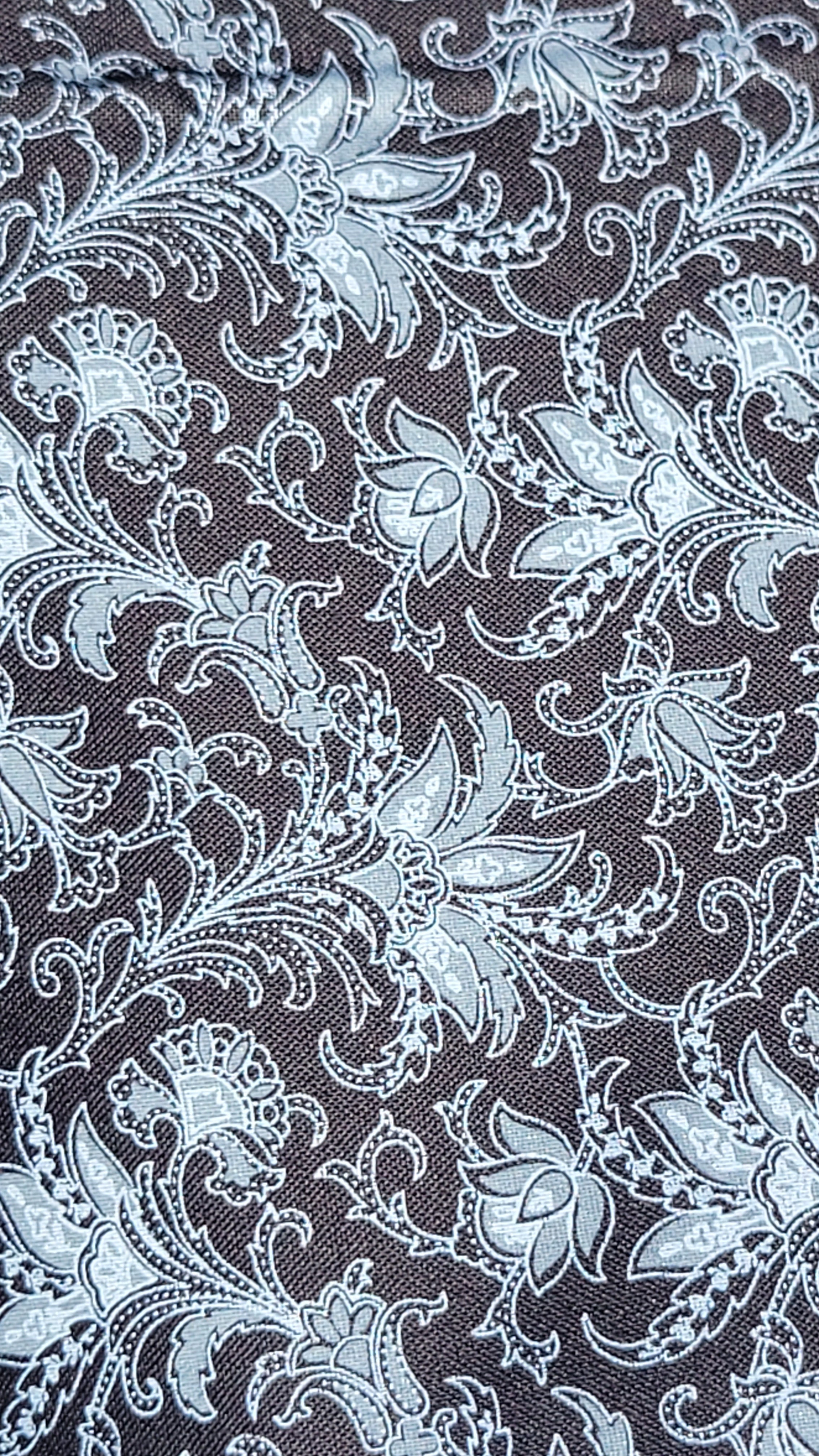 Detail White Paisley Pattern on Black Fabric.