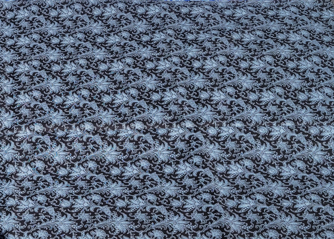 Detail White Paisley Pattern on Black Fabric.